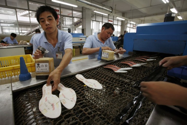 Image: Workers make soles at a shoe factory in Ganzhou, Jiangxi province